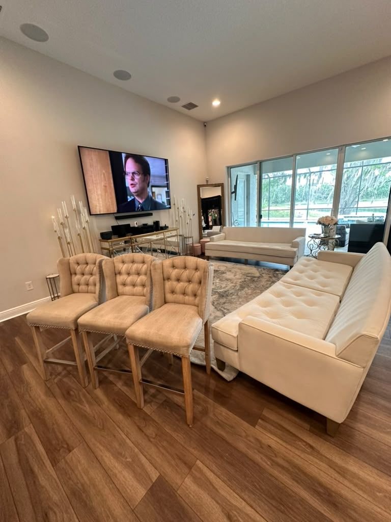 A cream tufted sofa in a bright living room after cleaning